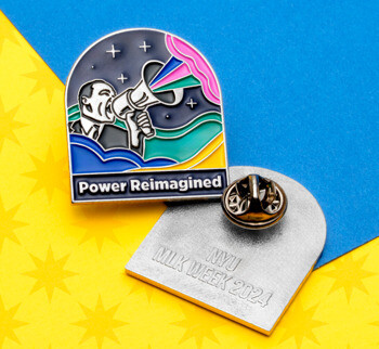 Arched lapel pin featuring a figure with a megaphone and 'Power Reimagined' text, alongside a silver back stamped with NYU MLK Week 2024.
