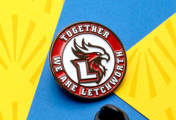 Circular lapel pin featuring a red and white Letchworth eagle logo with a black rubber clutch on a blue and yellow background.