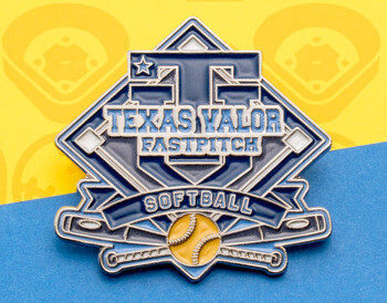 Custom Texas Valor Fastpitch Softball lapel pin featuring a navy blue and silver shield design with a yellow softball and crossed bats.