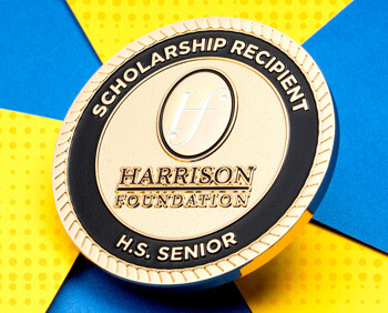 Gold and black Harrison Foundation Scholarship Recipient challenge coin for high school seniors.