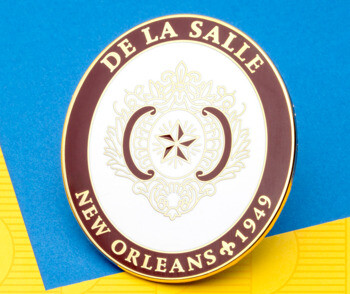 Circular De La Salle New Orleans 1949 lapel pin with maroon border, white center, and gold star emblem.