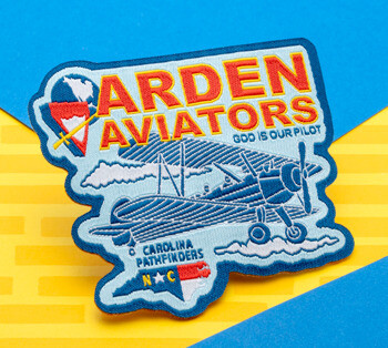 Embroidered patch for Arden Aviators Carolina Pathfinders featuring a blue biplane, clouds, and the North Carolina state shape.