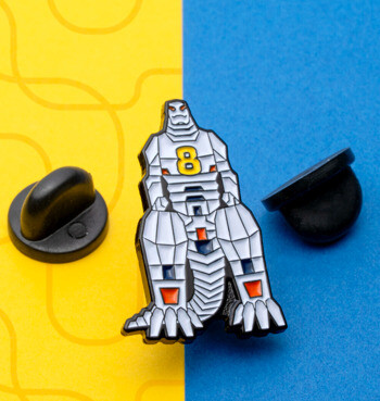 Enamel lapel pin featuring a white robotic mecha character with a yellow number 8 on its chest, displayed with black rubber backings.