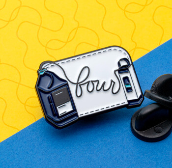 Soft enamel lapel pin featuring a medical device design with the word 'four' in script on a white background with a black rubber clutch.