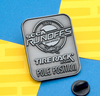 Rectangular antiqued silver lapel pin for 2024 SCCA Runoffs Road America Tire Rack Pole Position with a black rubber clutch.