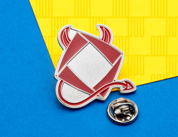 Red and silver lapel pin featuring a stylized envelope with devil horns and a pointed tail on a blue and yellow background.