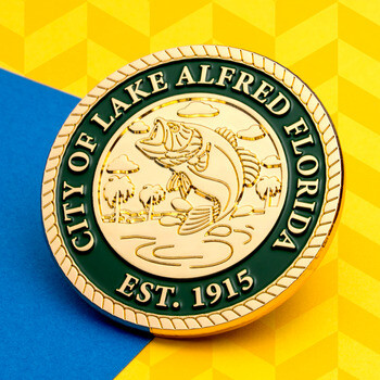 City of Lake Alfred Florida challenge coin with a gold leaping bass emblem and green border.