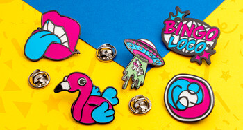 Set of colorful enamel lapel pins including Bingo Loco, a flamingo float, lips with blue tongue, and a UFO abducting a cow.